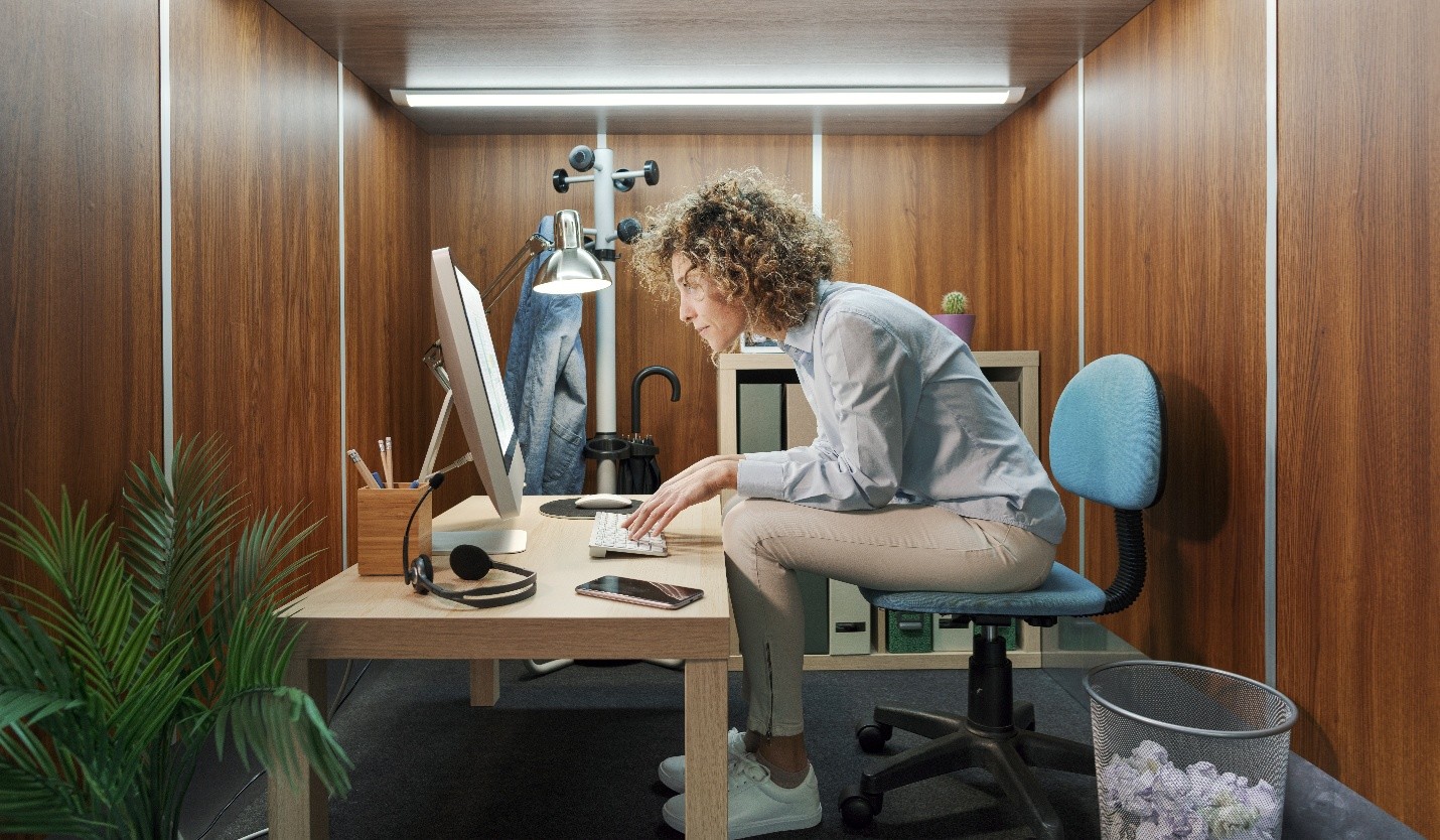 side view of young lade hunched over looking at her computer