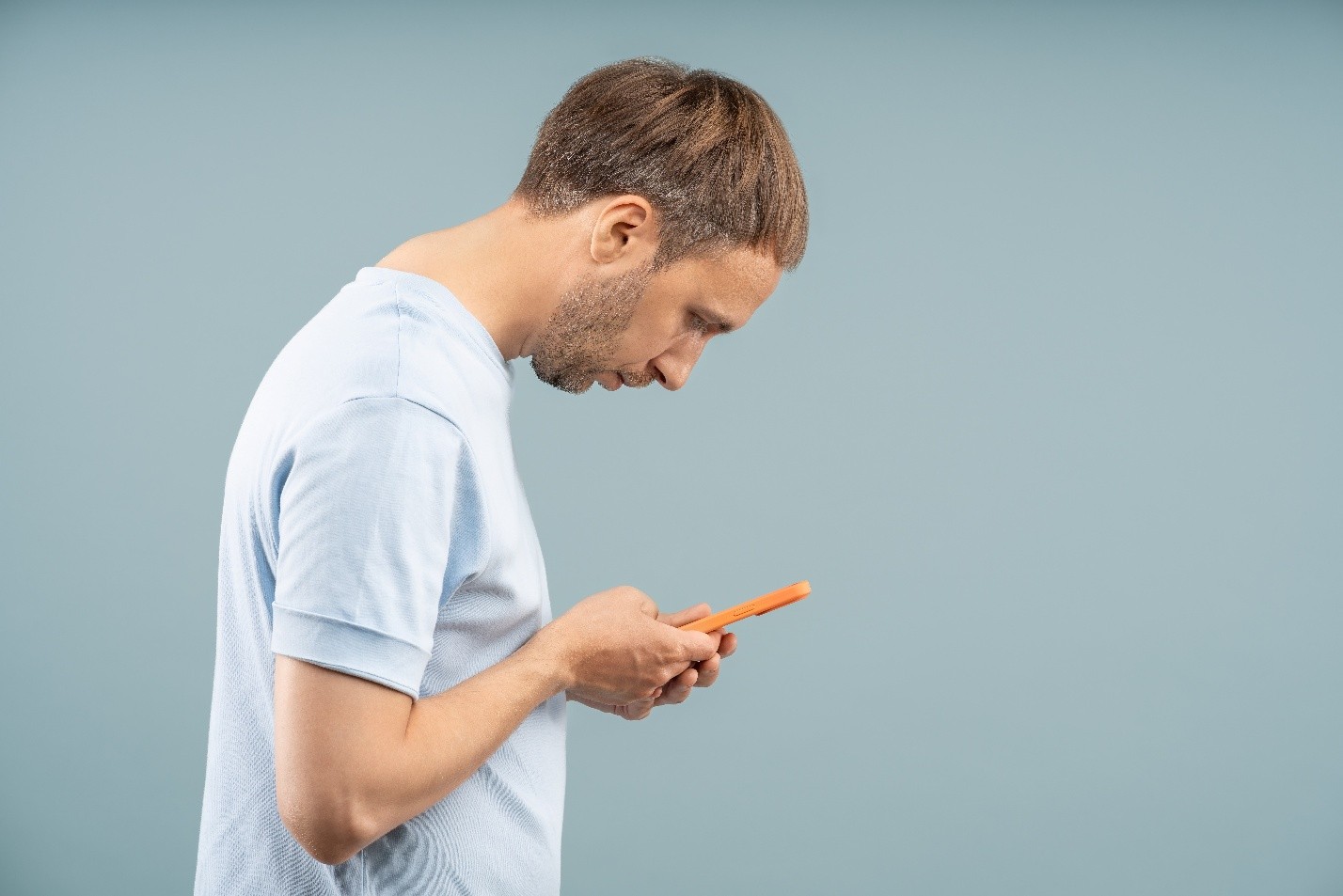 man looking down at his smart phone